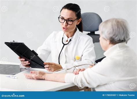 Healthcare In Hospital Concept Female Doctor Consulting Old Lady Stock
