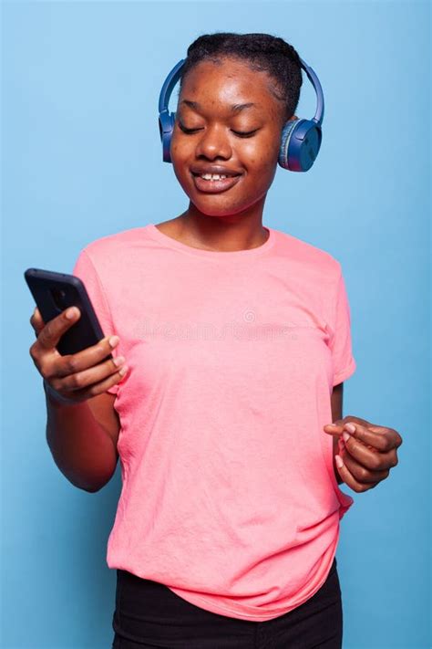 Portrait Of Positive African American Young Woman Wearing Headphones