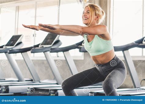 Sporty Woman Doing Squat For Exercising Thigh Muscle Stock Photo Image Of Caucasian Pose