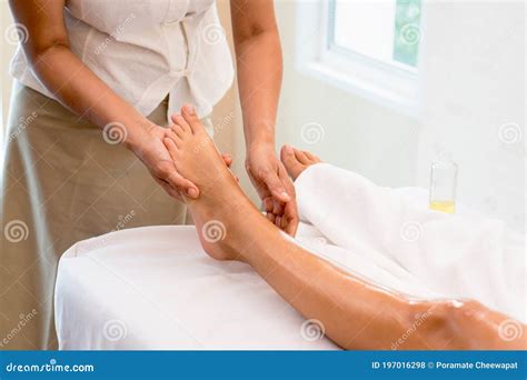 Relax With Aroma Oil Massage In Spa Salon Woman Lying On The Bed Relaxing With Foot Massage