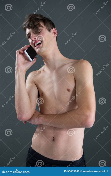 Shirtless Androgynous Man Talking On Mobile Phone Stock Photo Image