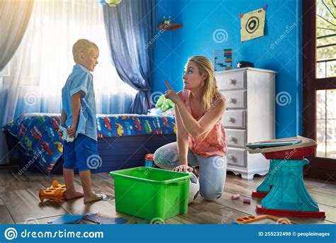Did I Not Ask You To Pack Your Toys Away A Mother Disciplining Her Son At Home Stock Photo