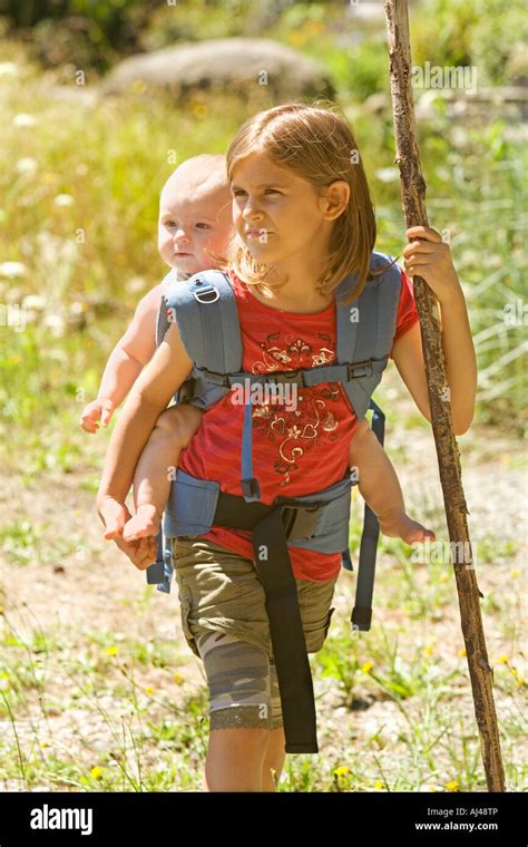 Girl Carrying Baby Sibling On Back Stock Photo Royalty Free Image