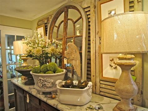 A Table Topped With Bowls Filled With Plants And Flowers Next To A