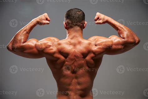 Male Bodybuilder Flexing His Biceps Back View 961419 Stock Photo At