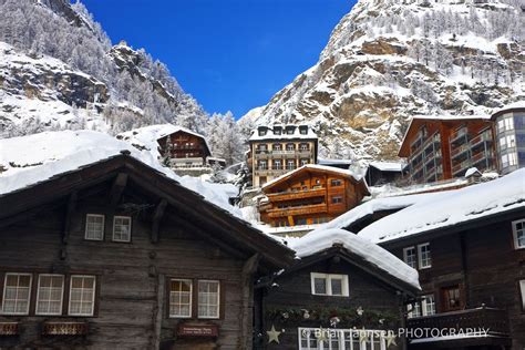 Quaint Alpine Village Houses Climb The Slopes Of The Swiss Alps