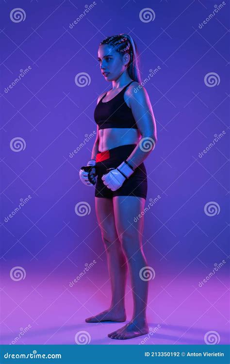Athletic Girl Mma Fighter Posing Isolated On Blue Background In Neon