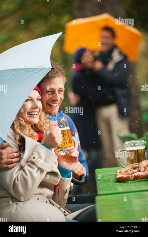 Germany Bavaria English Garden Four Persons In Rainy Beer Garden