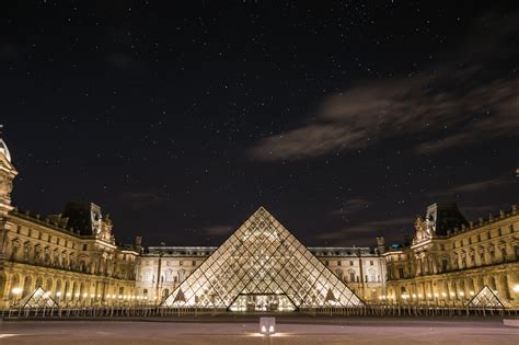The Illuminated Pyramid In Front Of The Louvre Museum In Paris At Night