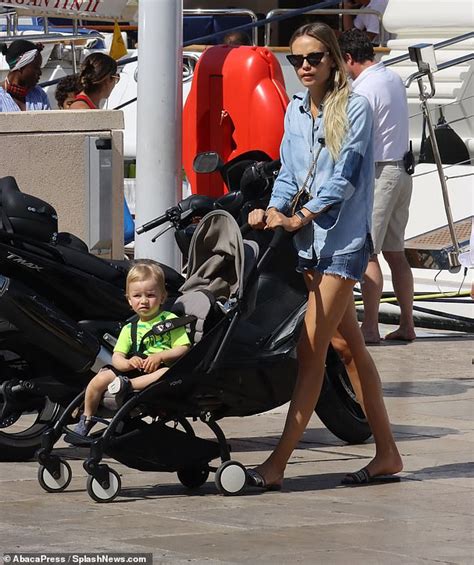 Natasha Poly Puts On A Leggy Display In Shorts As She Takes Her Son
