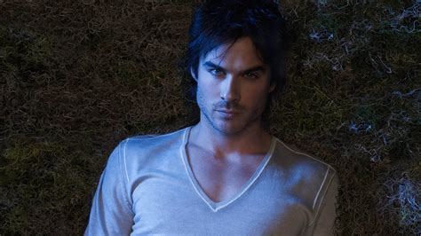 Damon Salvatore Is Lying Down On Green Grass Wearing White