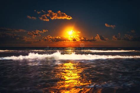 Full Moon Rising Over Sea Waves Dramatic Sunset Over Beach Stock Photo