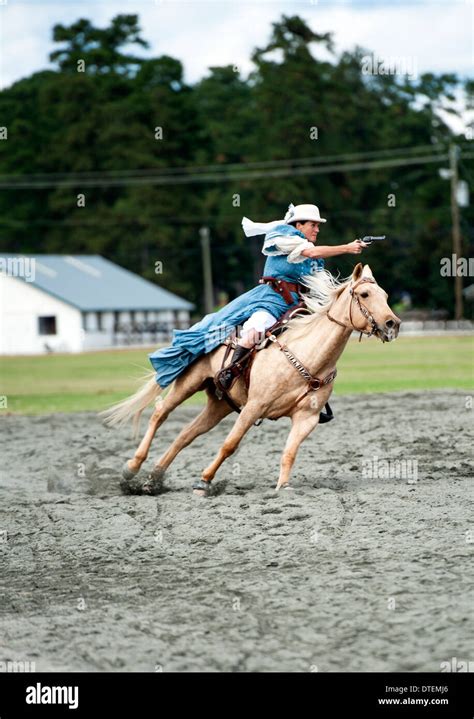 A Cowgirl On A Horse Riding At Full Gallop With Pistol Drawn Annie