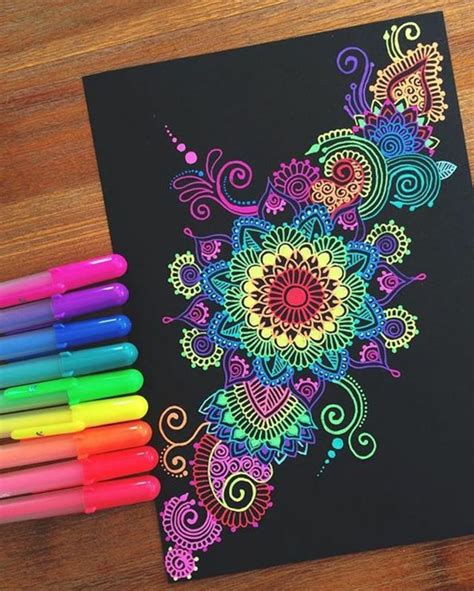 Some Markers Are Sitting Next To A Coloring Book With An Intricate