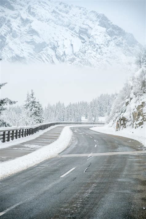Winding Road Through A Snow Covered Mountain Stock Photo