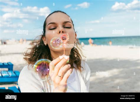 Woman Blow Bubbles On The Beach In The Summer Stock Photo Alamy