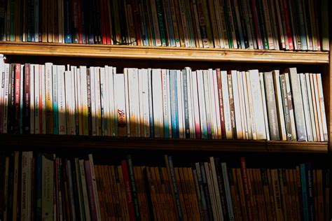 Assorted Title Books On Wooden Shelf · Free Stock Photo