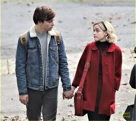 ross lynch and kiernan shipka hold hands while filming chilling adventures of sabrina photo