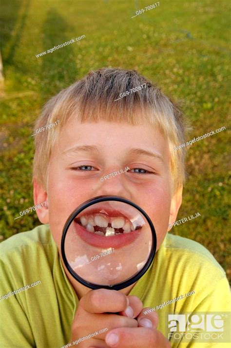 7 Year Old Boy With A Magnifying Glass Vasterbotten Sweden June 2005