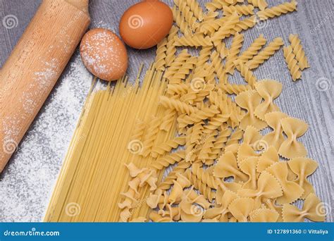 Various Types Or Raw Italian Pasta On The Wooden Rustic Background And