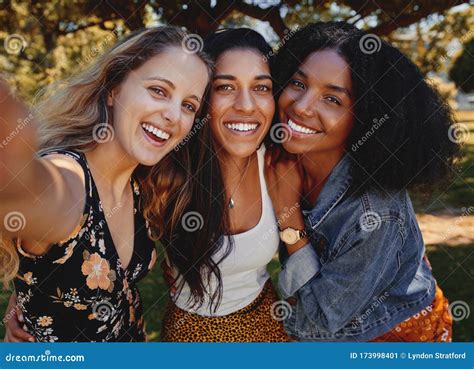 Close Up Self Portrait Of Smiling Young Multiethnic Female Friends Taking Selfie In The Park