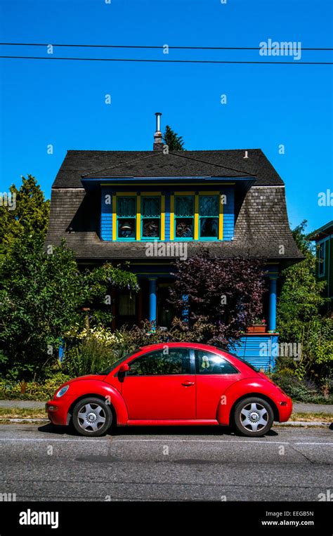 Bright Red Car Parked Outside Blue House In Seattle Usa Stock Photo