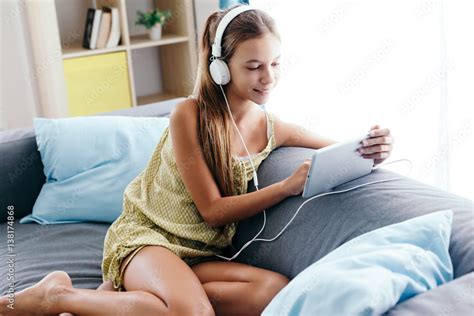 Tween Girl Relaxing On Couch At Home Stock Foto Adobe Stock