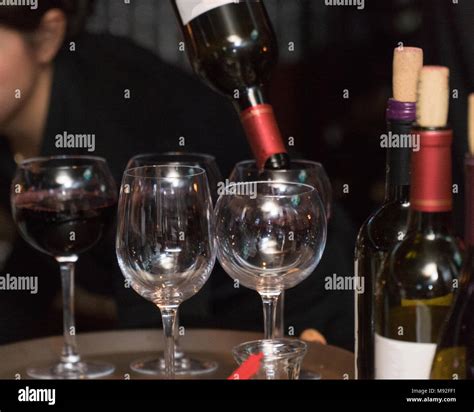 Restaurant Bartender Server Pour Bottle Of Wine Into Glass For Customer Drink Order During Fine