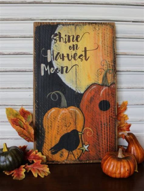 A Wooden Sign That Says Shine On Harvest Moon With Pumpkins And Gourds