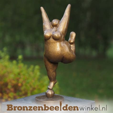 A Bronze Statue Of A Person Doing A Handstand
