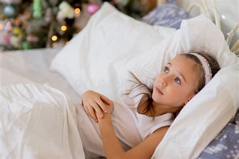 Child Girl Wake Up In Her Bed In Christmas Morning Stock Photo Image