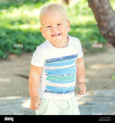 Baby Walking In The Park Stock Photo Alamy