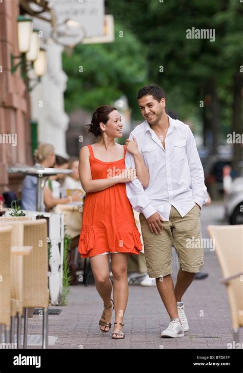 Couple Walking Down Street Stock Photo Alamy