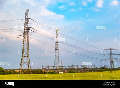 Power Masts On A Meadow In Germany Behind The Transformer Station You