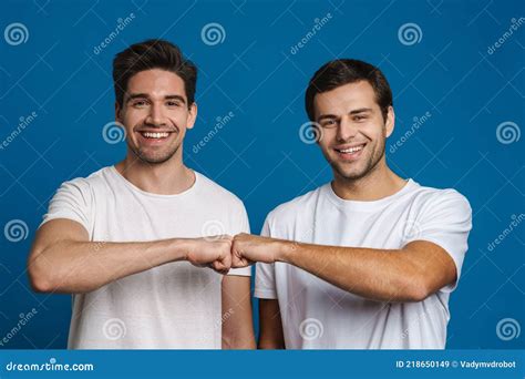 Joyful Handsome Friends Guys Smiling And Fist Bumping Stock Image Image Of Unshaven Blue