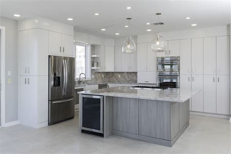 Dark grey cabinets on the lower half only make this room feel grand. Contemporary White Laminate Kitchen with Gray Island - Crystal Cabinets