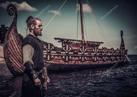 Viking warrior standing near Drakkar — Stock Photo © nejron #133496880