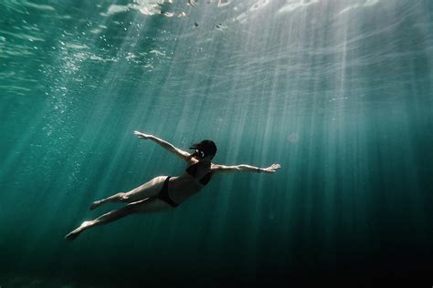Full Length Of Woman Swimming Underwater In The Ocean Photograph By