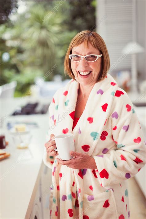 mature woman drinking coffee in bathrobe stock image f016 7502 science photo library