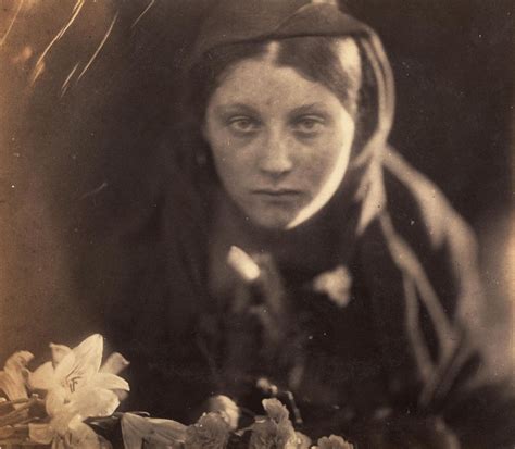 An Old Black And White Photo Of A Woman With Flowers