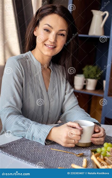 Attractive Happy Asian Girl Sitting And Laughing Drinking Tea At The