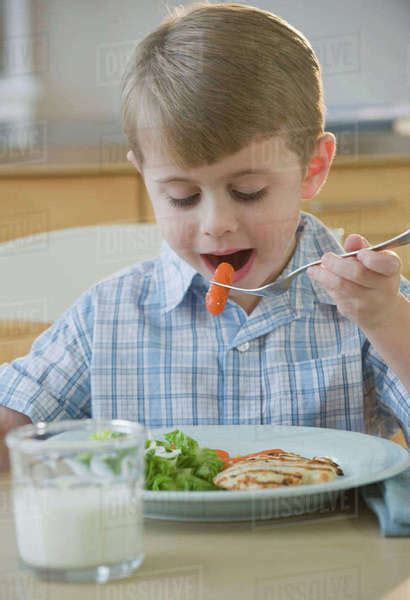 Boy Eating Dinner Stock Photo Dissolve