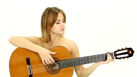 Naked Blonde Girl Sitting And Finished Playing Guitar 1 Stock Footage