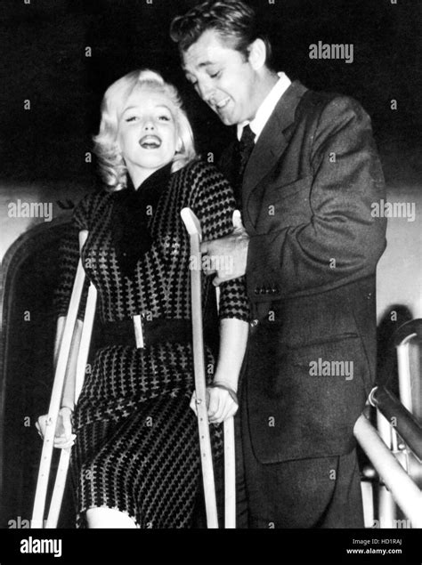 Marilyn Monroe On Crutches Is Assisted By Robert Mitchum Ca 1954