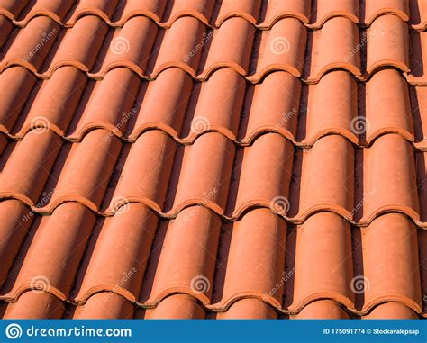 Closeup Of The Red Clay Roof Tiles Shingles Old And Used Overlapping