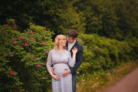 image of beautiful pregnant woman and her handsome husband hugging the tummy stock image image