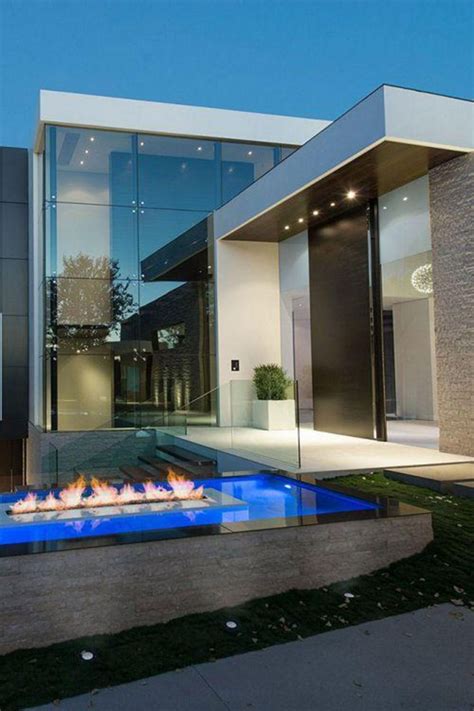 A Fire Pit In Front Of A Modern House