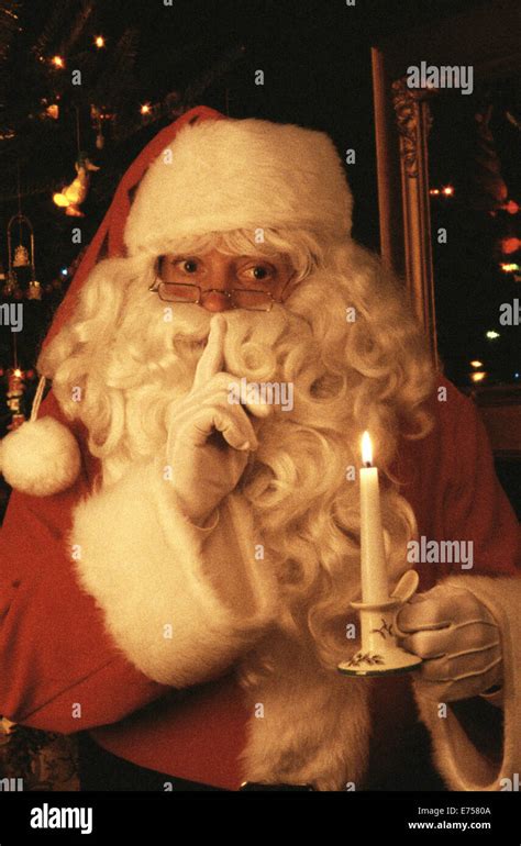 Santa Claus With Candle Gesturing Silence With Finger To Lips Shhhhh