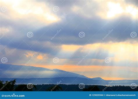 Ray Of Beautiful Sun Light Shines Through The Cloud Over The Mountain