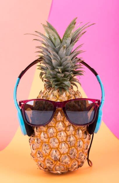 Premium Photo Pineapple With Sunglasses And Headphone On Orange